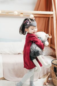 Smiling girl holding stuffed bunny