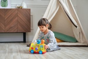 Young Girl Playing with Toy Car