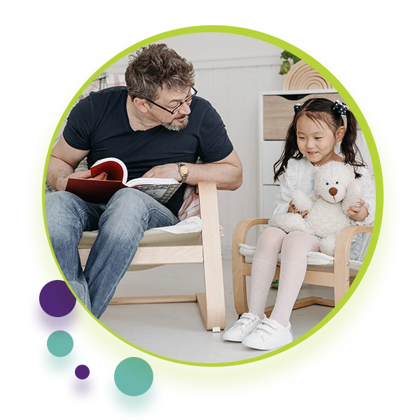Social Worker and child sitting next to eachother, reading a book. - Decorative image for Communication Clubhouse Therapy Social Work Page