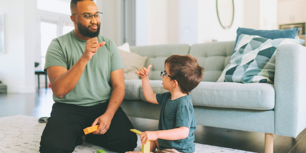 deaf child practicing sign language with speech therapist