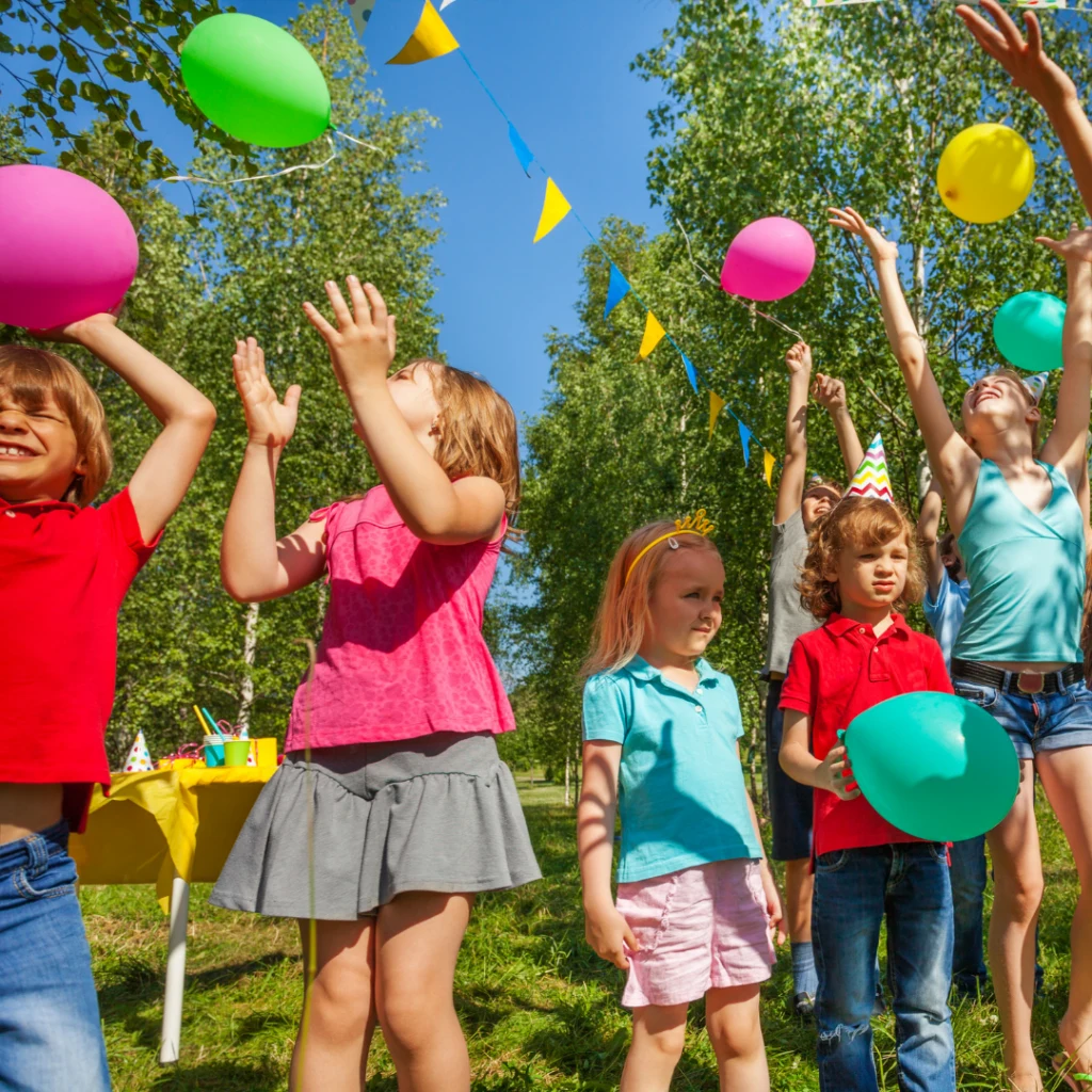 Children playing with balloons outdoors